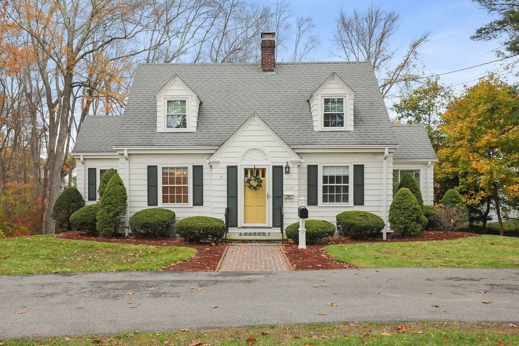 1297 Old Worcester Road Framingham, MA 01701 - Photo 2 of 41 a front view of a house with a yard and plants