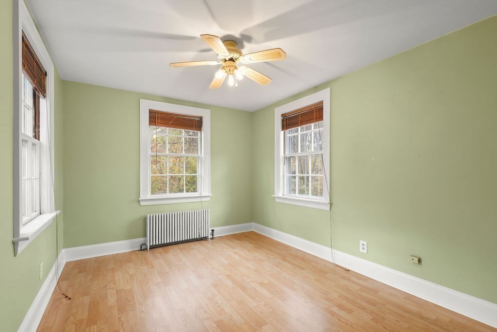 1297 Old Worcester Road Framingham, MA 01701 - Photo 21 of 41 a view of an empty room with a window and wooden floor