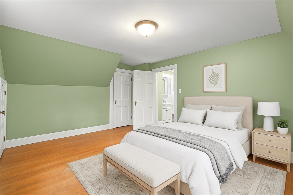 1297 Old Worcester Road Framingham, MA 01701 - Photo 22 of 41 a spacious bedroom with a bed and a couch