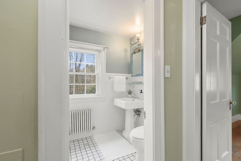 1297 Old Worcester Road Framingham, MA 01701 - Photo 25 of 41 a bathroom with a toilet a sink and a window