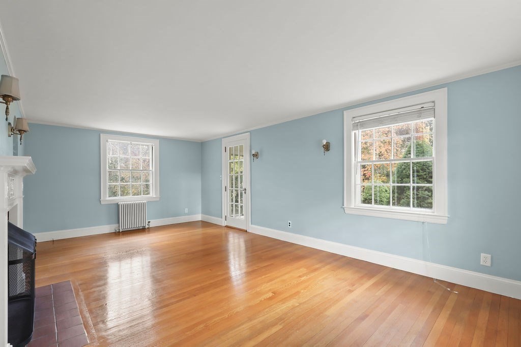 1297 Old Worcester Road Framingham, MA 01701 - Photo 8 of 41 a view of an empty room with wooden floor and a window
