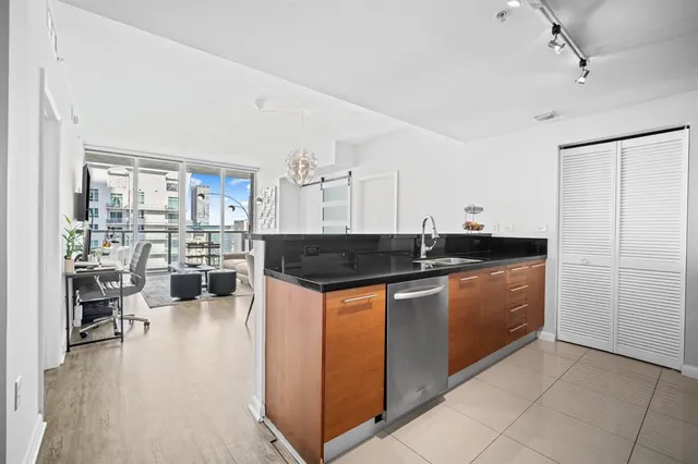 a kitchen with stainless steel appliances granite countertop a stove and a refrigerator