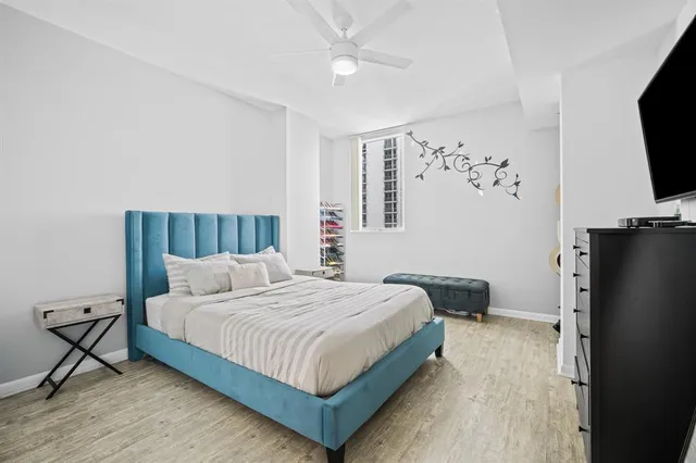 a bedroom with a bed and a flat screen tv