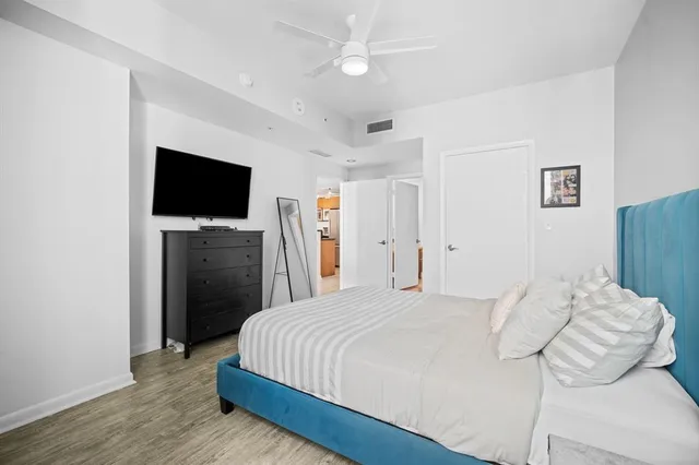 a bedroom with a bed and a flat screen tv