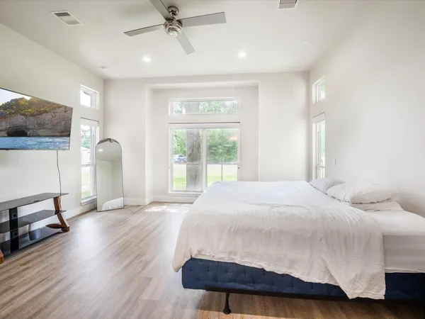 a bathroom with a tub a sink and a window