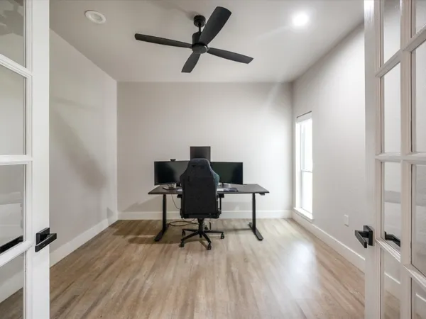 a view of a workspace with furniture and a mirror