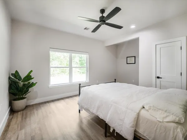 a bathroom with a granite countertop sink a toilet and bathtub