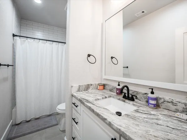 a living room with furniture fireplace and a large window