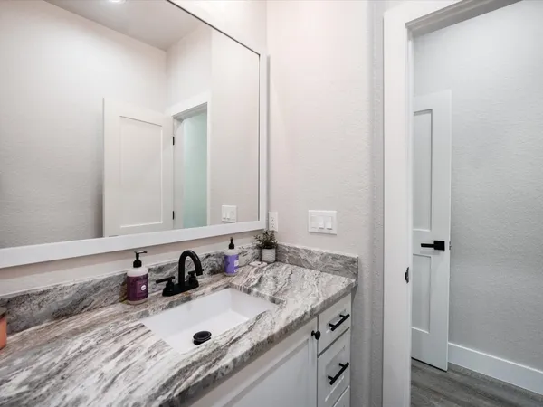 a living room with furniture fireplace and large windows