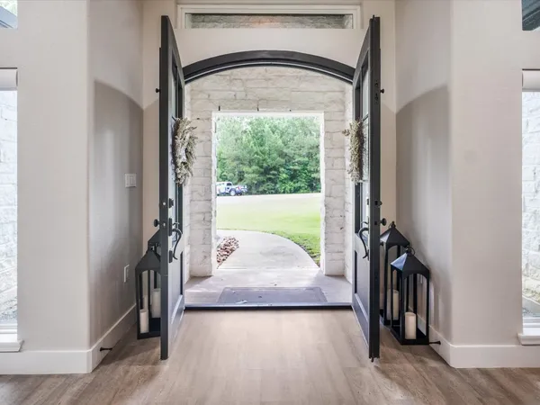 a kitchen with kitchen island a counter space a sink stove and wooden floor