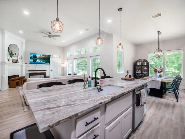a bedroom with a bed a window and flat screen tv