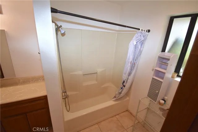 a bathroom with a shower and a glass door