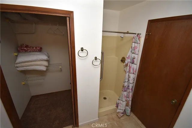 a bathroom with a shower and a door