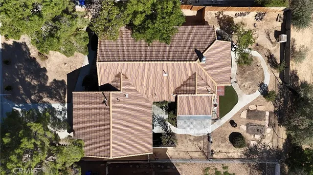an aerial view of a house with a yard