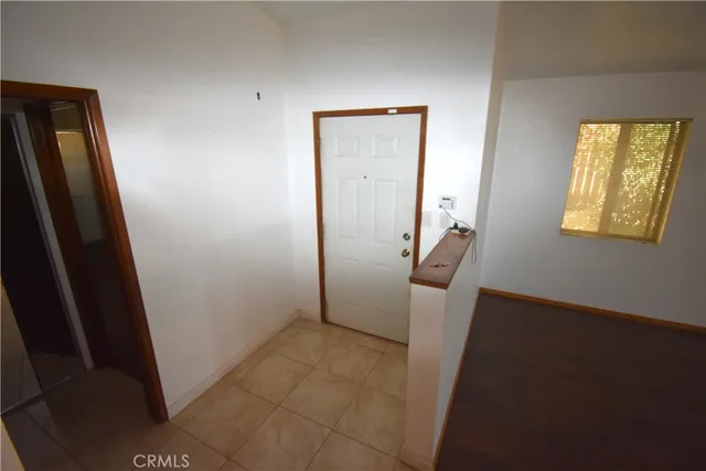 a view of a hallway to rooms