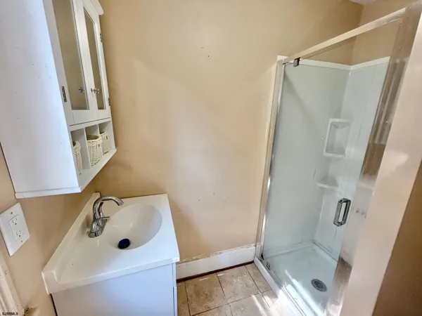 a bathroom with a sink and shower