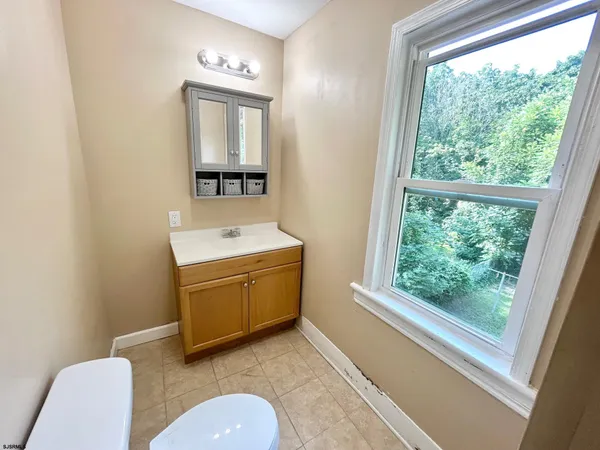 a bathroom with a toilet a sink and mirror