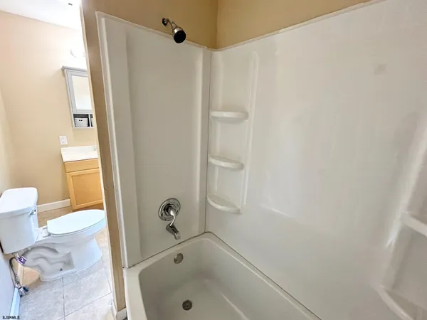 a bathroom with a tub and a shower