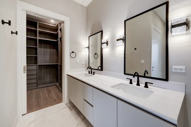 an empty room with wooden floor and a bathroom