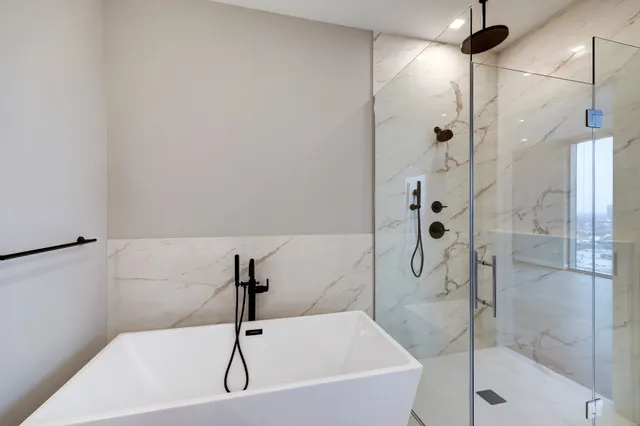 a bathroom with a double vanity sink a mirror and a shower