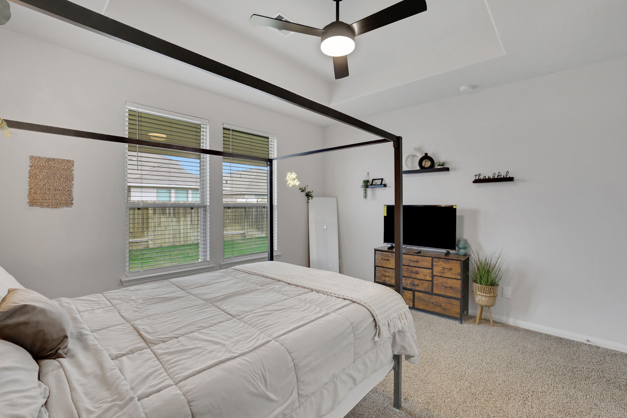 11208 Danny Lane Willis, TX 77318 - Photo 22 of 43 a bedroom with a bed and a flat screen tv