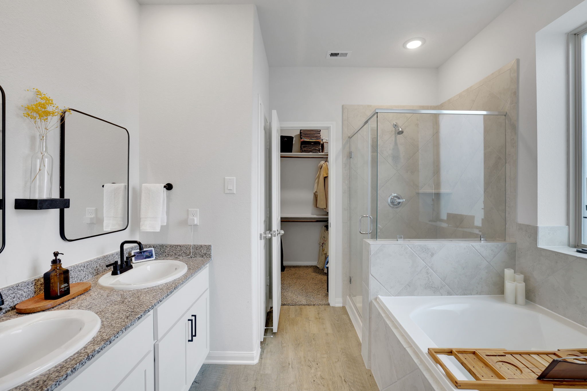 11208 Danny Lane Willis, TX 77318 - Photo 23 of 43 a bathroom with a tub sink and mirror