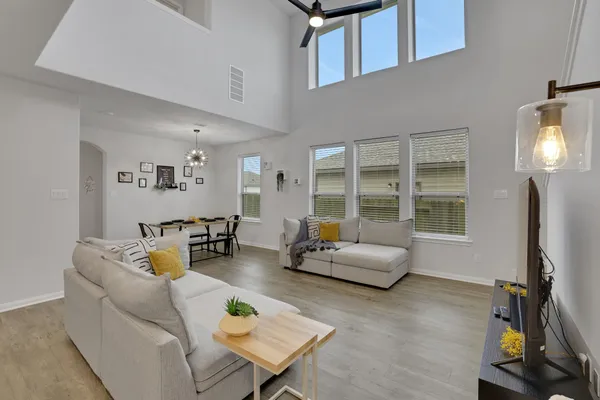 a living room with furniture and kitchen view