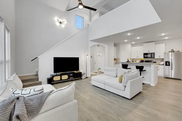 a kitchen with stainless steel appliances granite countertop a refrigerator sink and stove