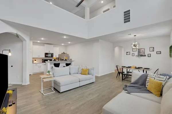 a kitchen with stainless steel appliances kitchen island a refrigerator a stove a sink and dishwasher with wooden floor