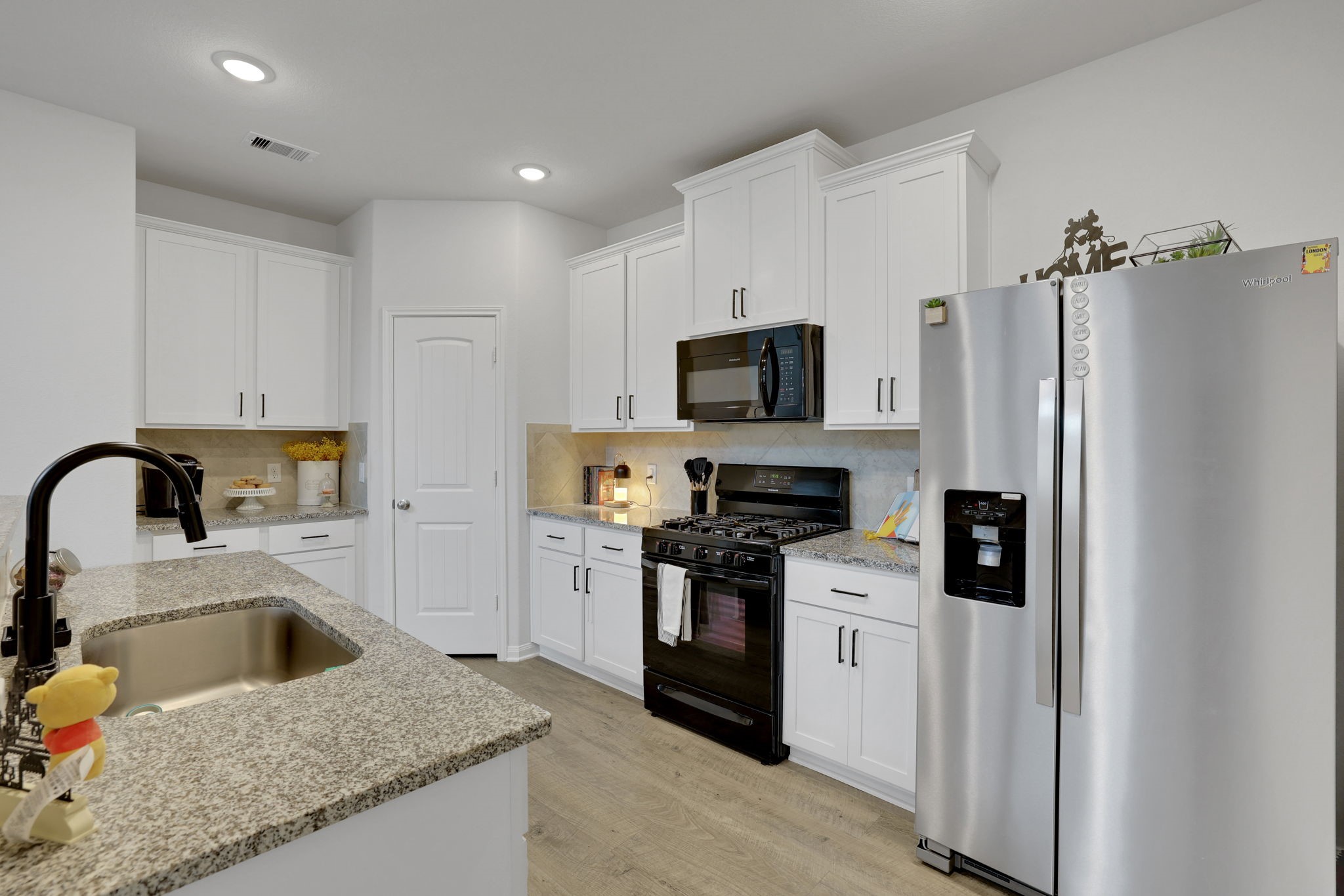 11208 Danny Lane Willis, TX 77318 - Photo 6 of 43 a kitchen with stainless steel appliances granite countertop a refrigerator sink and stove
