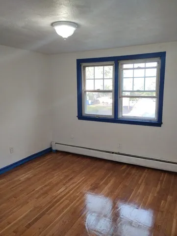 a bathroom with a granite countertop sink mirror vanity and toilet