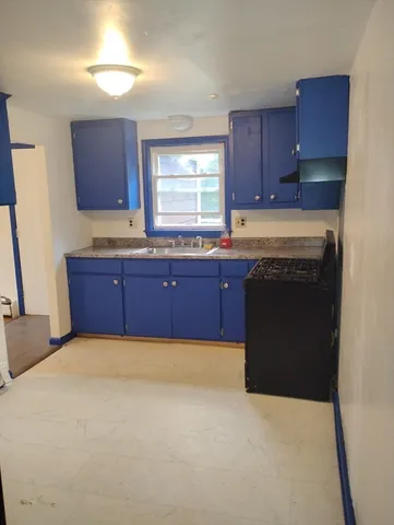 a kitchen with a stove a sink and a refrigerator