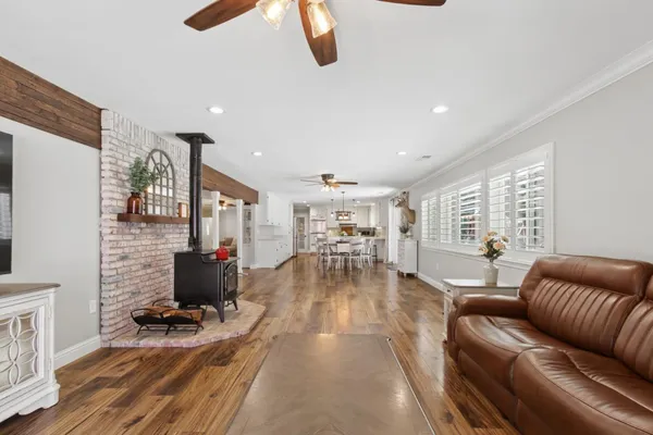 a large kitchen with cabinets wooden floor and stainless steel appliances