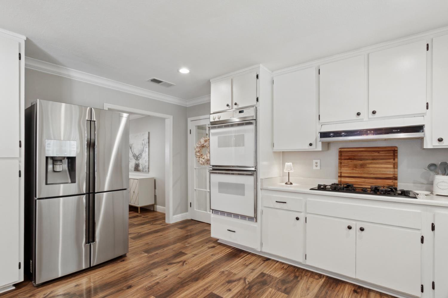33837 Nary Red Road Alta, CA 95701 - Photo 36 of 74 a kitchen with granite countertop white cabinets and stainless steel appliances