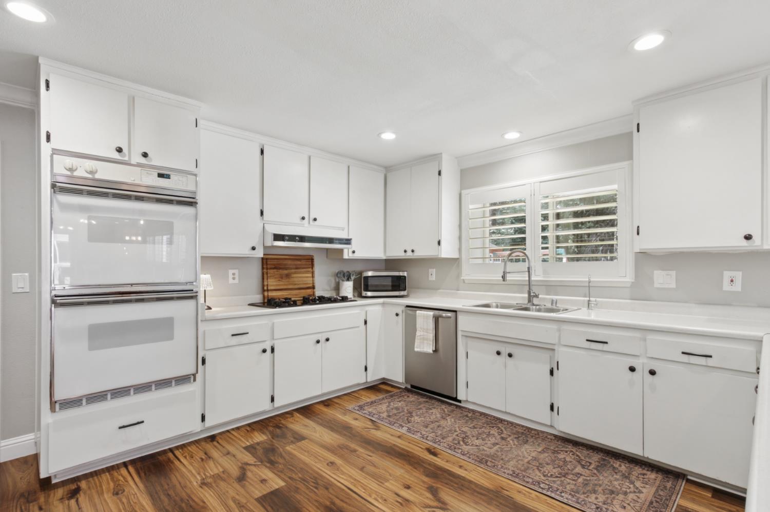 33837 Nary Red Road Alta, CA 95701 - Photo 37 of 74 a kitchen with granite countertop white cabinets and white appliances