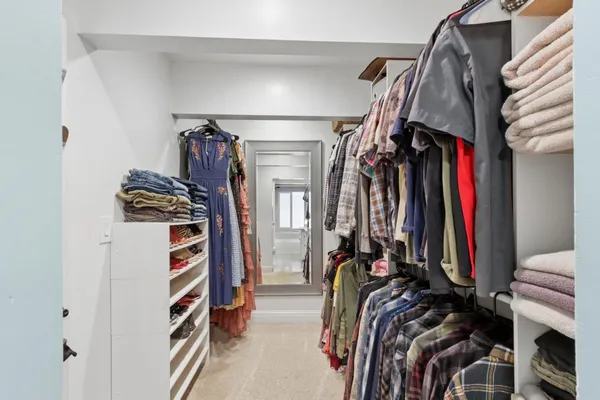 a view of a house with a yard and large trees