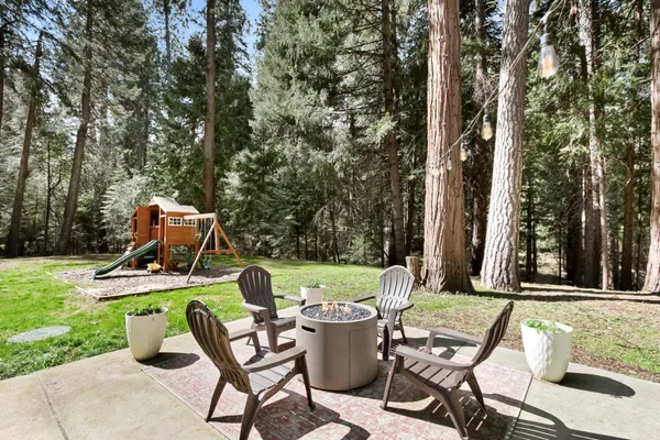 a front view of a house with basket ball court and a outdoor space