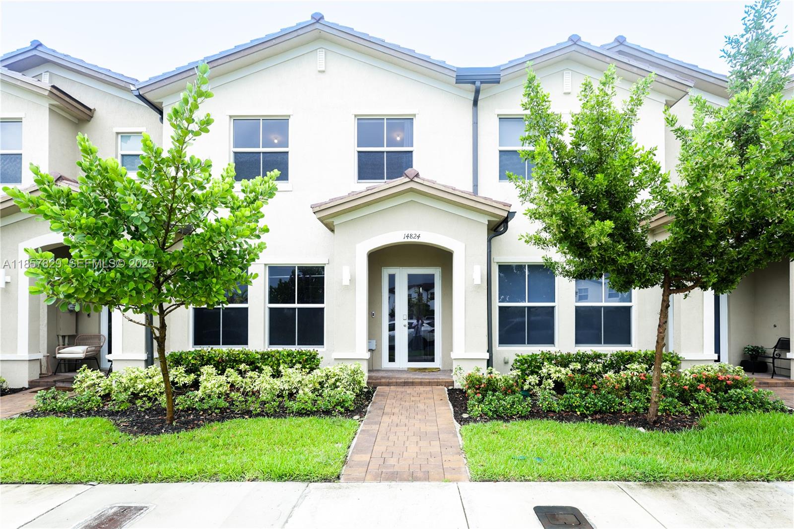 a front view of a house with garden