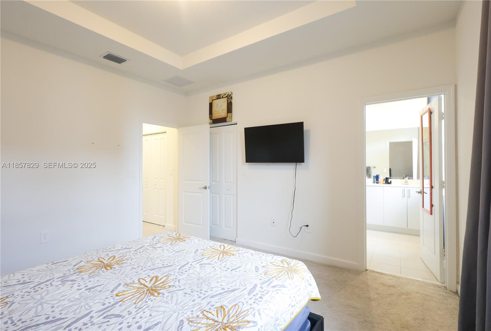 14824 Southwest 265th Street Homestead, FL 33032 - Photo 12 of 17 a bedroom with a bed and a flat screen tv