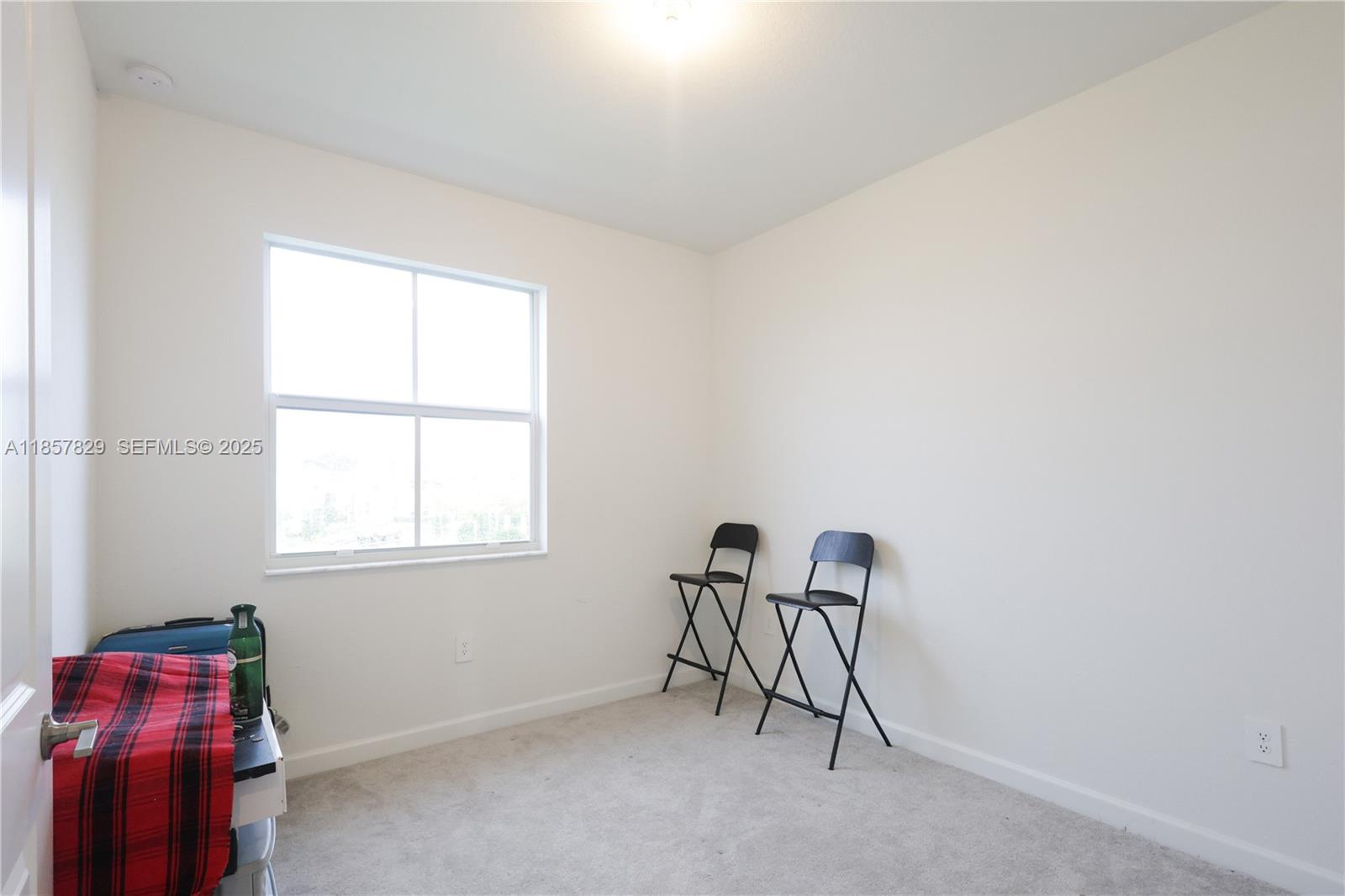 14824 Southwest 265th Street Homestead, FL 33032 - Photo 16 of 17 a room with furniture and a window