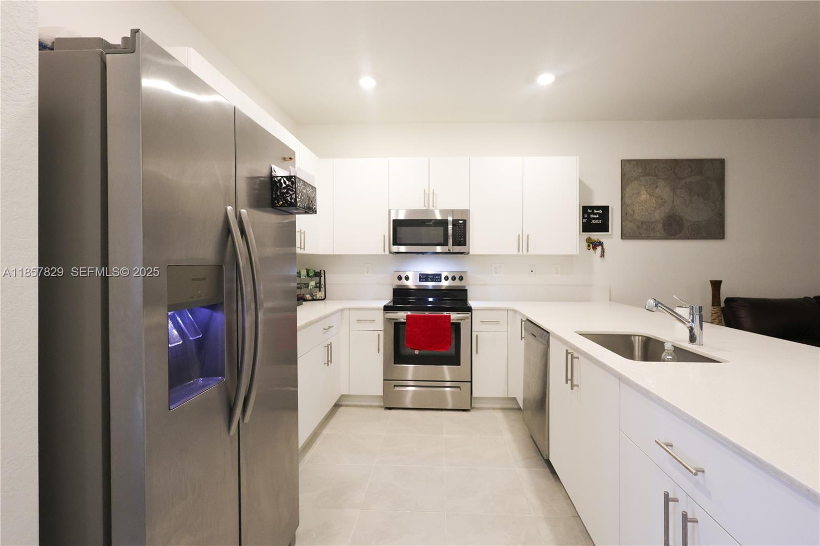 14824 Southwest 265th Street Homestead, FL 33032 - Photo 3 of 17 a kitchen with stainless steel appliances granite countertop a refrigerator and a sink