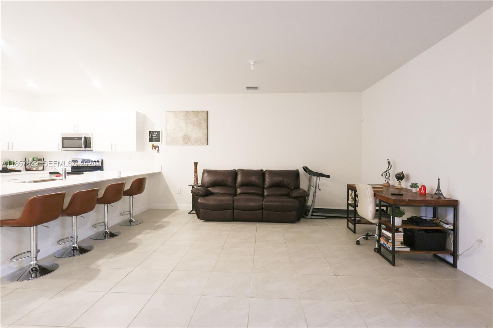 14824 Southwest 265th Street Homestead, FL 33032 - Photo 5 of 17 a living room with furniture and a flat screen tv
