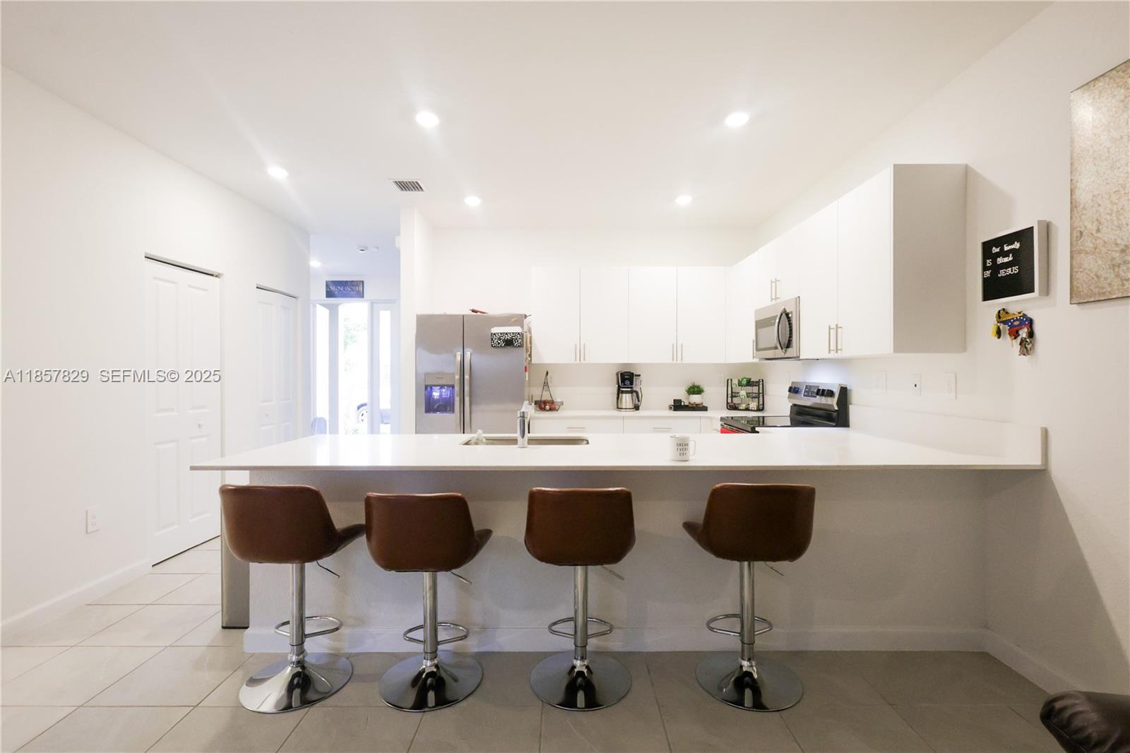 14824 Southwest 265th Street Homestead, FL 33032 - Photo 6 of 17 a kitchen with cabinets and chairs