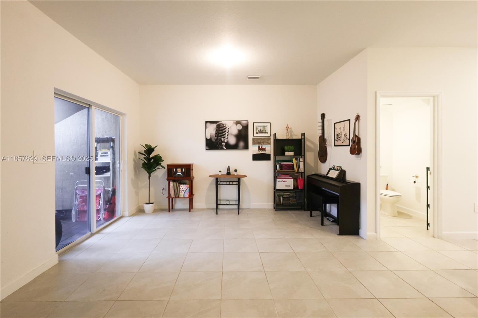 14824 Southwest 265th Street Homestead, FL 33032 - Photo 7 of 17 a view of a livingroom with workspace and a window
