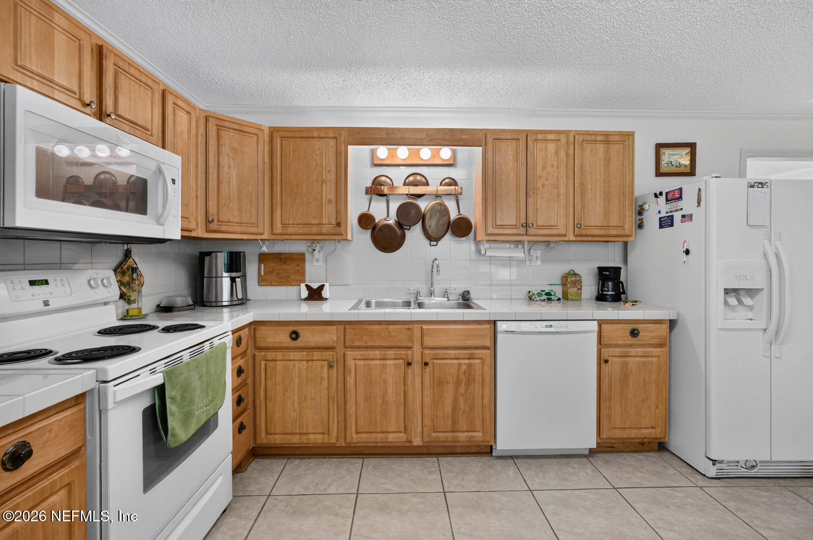 1950 Lightsey Road St. Augustine, FL 32084 - Photo 17 of 57 a kitchen with stainless steel appliances granite countertop a sink and cabinets