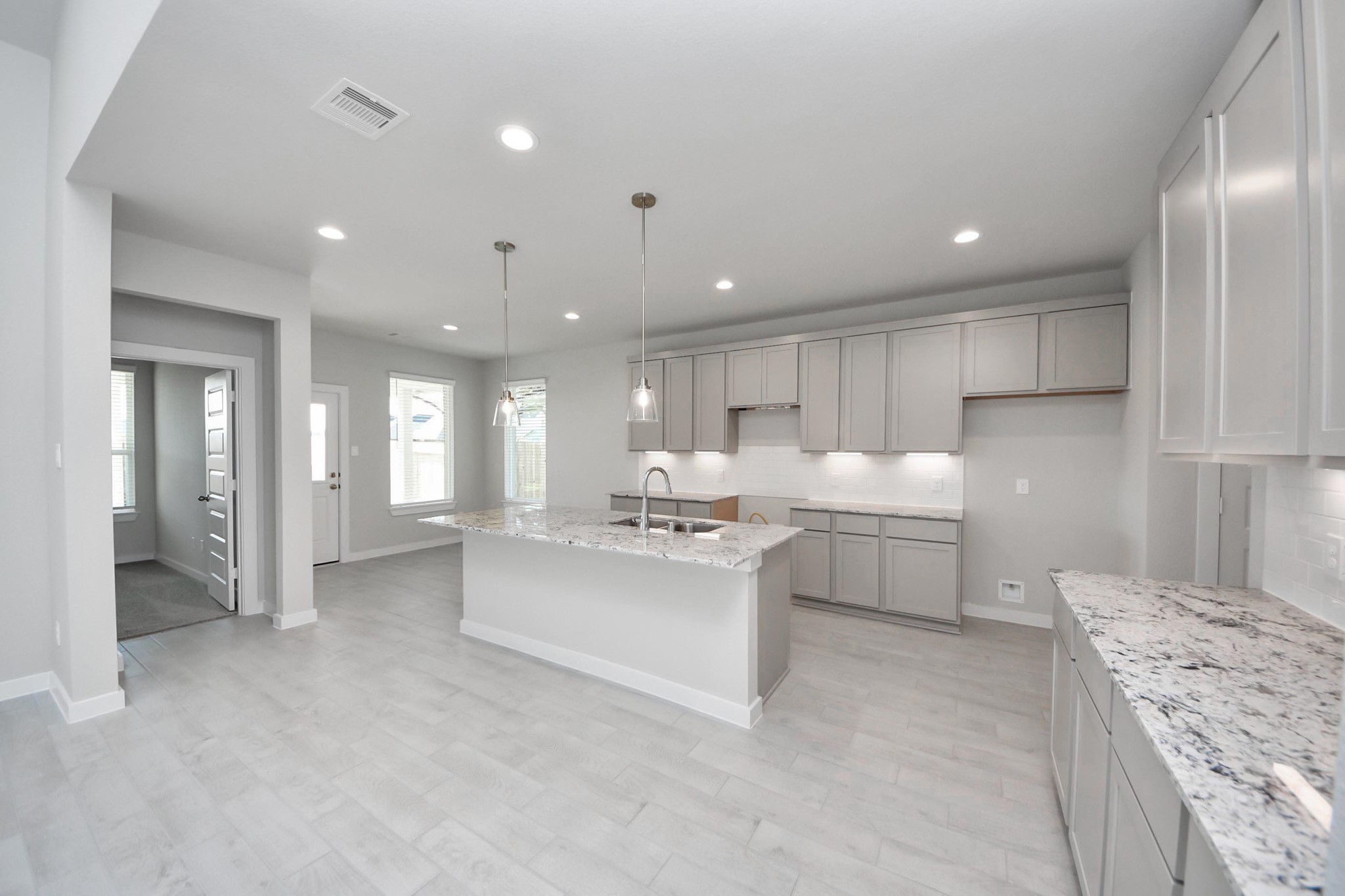15715 Telge Ridge Lane Cypress, TX 77429 - Photo 13 of 48 a kitchen with kitchen island a sink stainless steel appliances and cabinets