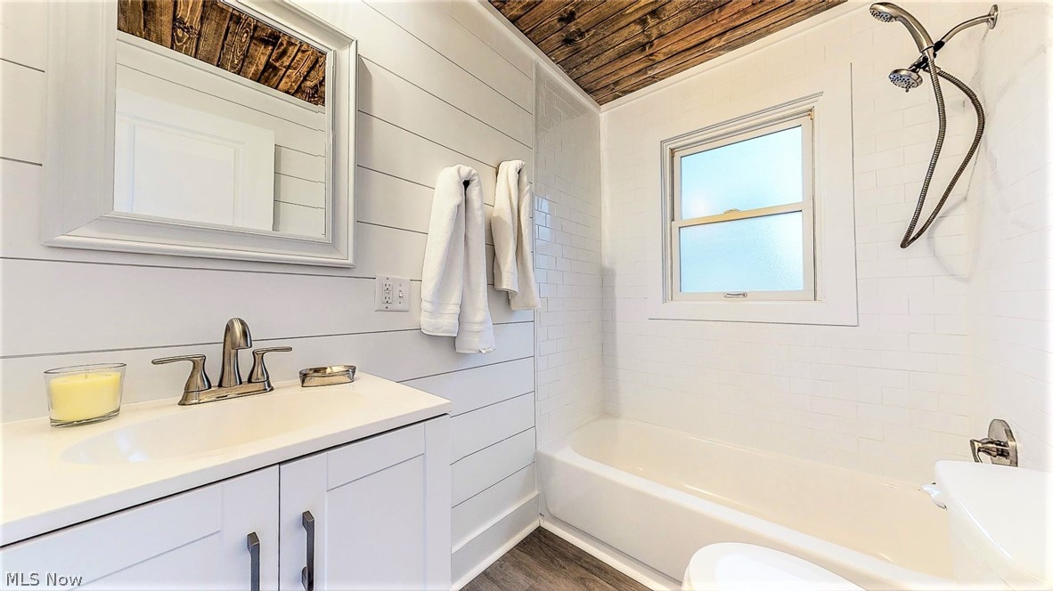 2152 McCoy Road Akron, OH 44320 - Photo 25 of 32 *MASTER BATHRM NEW AND ADDED WITH SHIPLAP WALLS, RUSTIC WOOD CEILING, TUB AND SHOWER, SUBWAY TILED SURROUND, PLANK FLOORING, VANITY, MIRROR AND LIGHTING ~