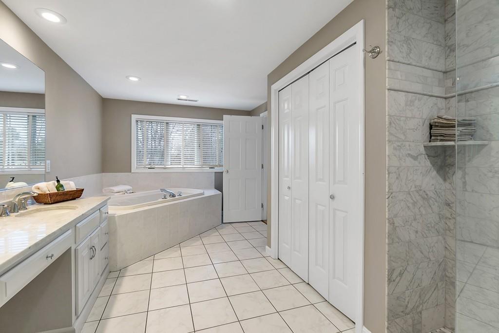 2 Sunset Rock Road Andover, MA 01810 - Photo 26 of 42 a bathroom with a granite countertop sink a mirror and a bathtub