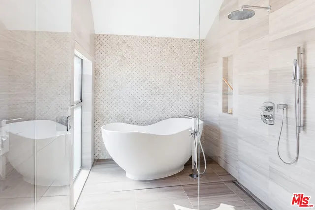 a bathroom with a bathtub and shower