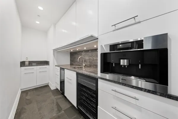 a kitchen with stainless steel appliances granite countertop a sink stove and cabinets